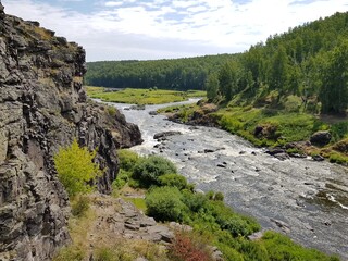 Fototapeta na wymiar Large boulders lie in a mountain river