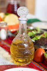 Close up of a tequila bottle standing in the middle of a table set