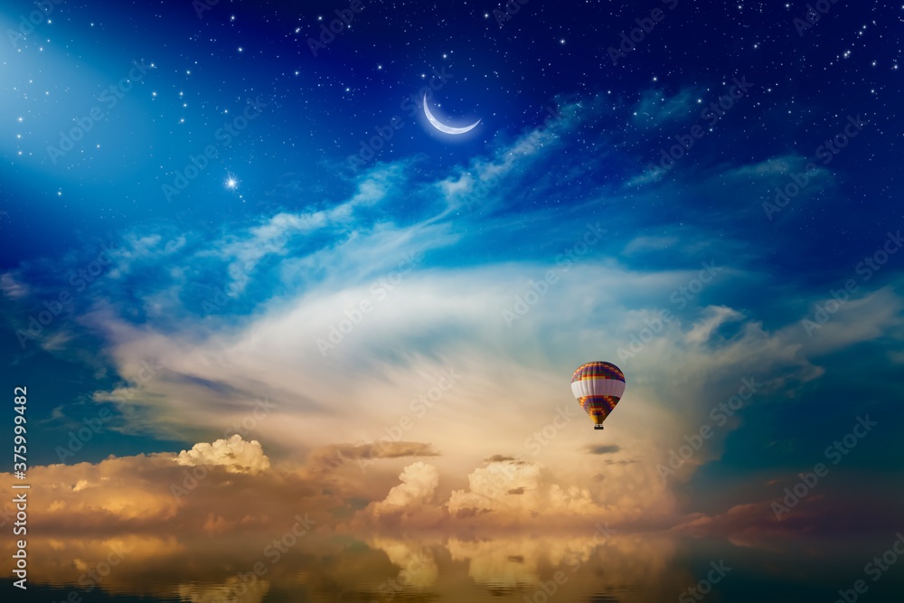 Poster Light from heaven, crescent and hot air balloon rising above serene sea in sunset glowing sky