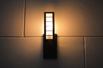 Orange incandescent light bulb mount on wall