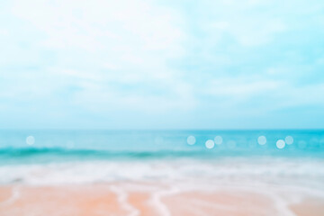 Blur tropical nature clean beach and white sand in summer with sun light blue sky and bokeh