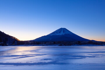 夜明けの富士山と全面氷結した精進湖　山梨県富士河口湖町にて