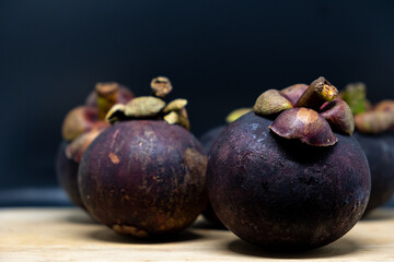 Closeup view of ripe mangosteen on wooden table