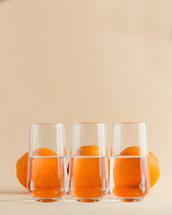 Oranges for glasses of water. Distorted image of water. Art concept, trending photo. Minimalism. Copy space.