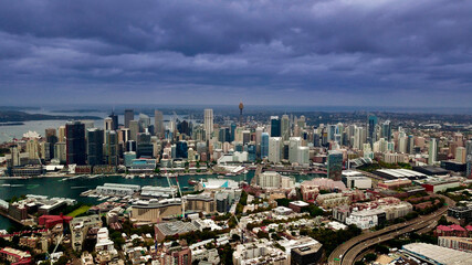 Fototapeta na wymiar Panoramic drone aerial view over Sydney harbour on a cloudy sunset showing the nice colours of the CBD aparments and officer towers