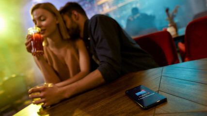 Message from wife. Unfaithful man spending time with another woman flirting in the bar, enjoying...