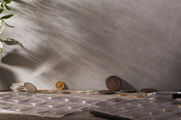 Numismatics. Old collectible coins made of silver, gold and copper on a wooden table. - obrazy, fototapety, plakaty