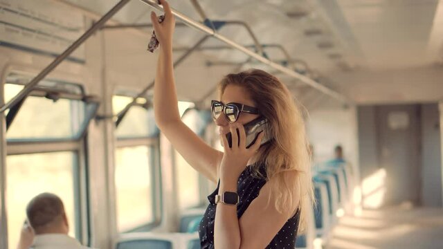 Handsome Attractive Woman Talking On Cellphone Or Smartphone In Tram.Female In Sunglasses Using Mobile Phone And Call To Husband In Trolleybus.Successful Confident Woman Calling On Phone In Train.