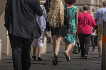 woman with long blond hair walks