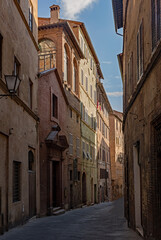Fototapeta na wymiar Narrow street at the old town of Siena, Tuscany Region in Italy 