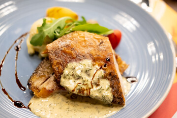 Sea bass fillet steak with lemon sauce served with vegetable