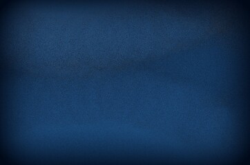 Dark blue grungy canvas background or texture with dark vignette borders
