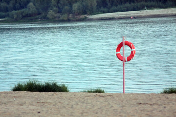 orange life saver on the beach near the river