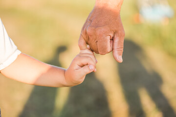 The grandfather holds grandson in a lap park
