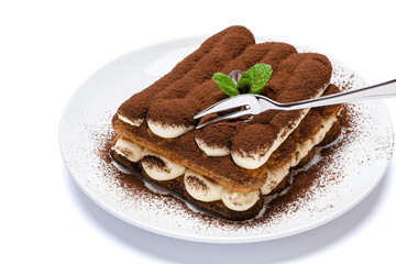 portion of Classic tiramisu dessert on ceramic plate isolated on white background with clipping path