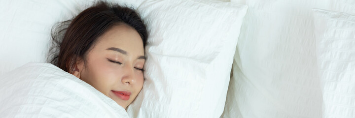 Asian women sleeping and sweet dream on white bed in bedroom
