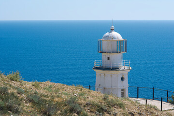Fototapeta na wymiar The lighthouse at cape Meganom, Crimea.