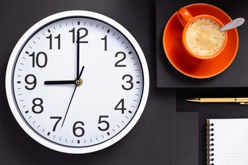 wall clock, cup of coffee and checked notebook