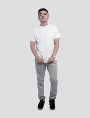 Fototapeta premium Young handsome man wearing white t shirt posing on white background