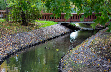 Fototapeta na wymiar canal with water brick bridge in the park