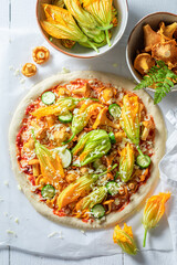 Ingredients for homemade pizza with chanterelles, zucchini and mozzarella