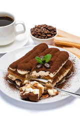 portion of Classic tiramisu dessert, savoiardi cookies and cup of fresh espresso coffee isolated on white background with clipping path
