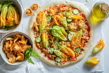 Preparations for vegetarian pizza made with zucchini flower and mushrooms