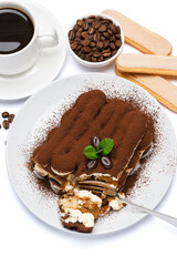 portion of Classic tiramisu dessert, savoiardi cookies and cup of fresh espresso coffee isolated on white background with clipping path