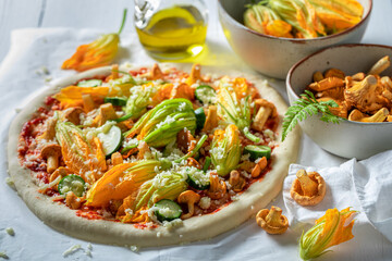 Ingredients for homemade pizza made with zucchini flower and mushrooms
