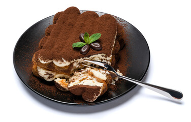 portion of Classic tiramisu dessert on ceramic plate isolated on white background with clipping path