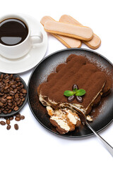 portion of Classic tiramisu dessert, savoiardi cookies and cup of fresh espresso coffee isolated on white background with clipping path