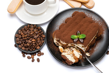 portion of Classic tiramisu dessert, savoiardi cookies and cup of fresh espresso coffee isolated on white background with clipping path