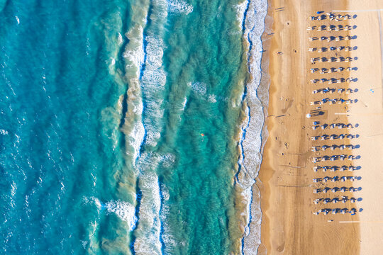 Aerial top down view to the beautiful beach of Kyllini, West Peloponnese, Greece, with umbrellas in the golden sand