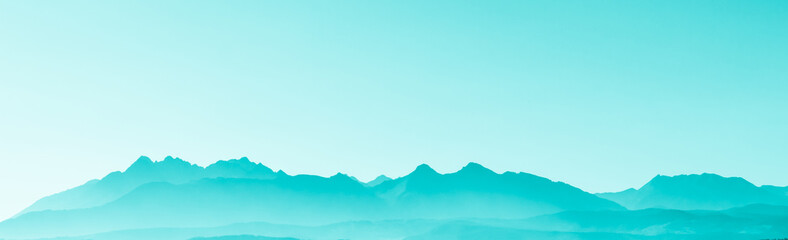 Green surreal mountains against the backdrop of a turquoise sky, fantastic fairytale mountain landscape