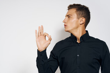 Man in black shirt lifestyle emotions modern style cropped view light background