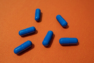 Blue pills on the orange background