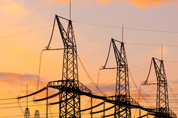 Power lines against the sunset sky. Electrical substation