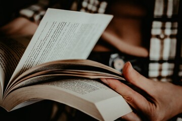 A man holds a book in his hands. The page is turned
 
