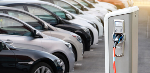 Close-up of a electric charging station on the background of cars