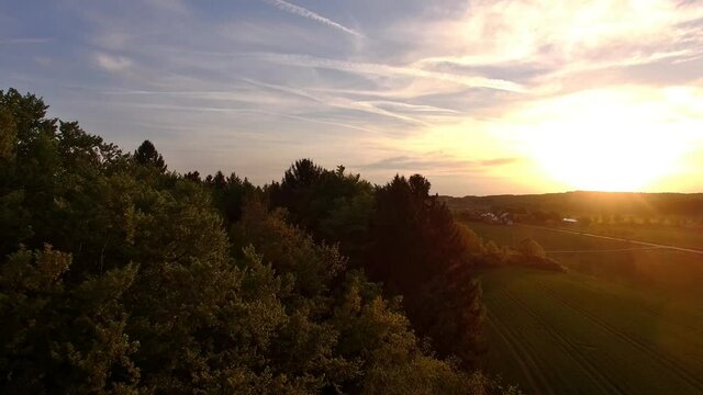 Drone is flying above bavarian fields during sunset