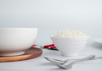 White soup cup with side dishes placed on a white background.