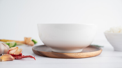 White soup cup with side dishes placed on a white background.