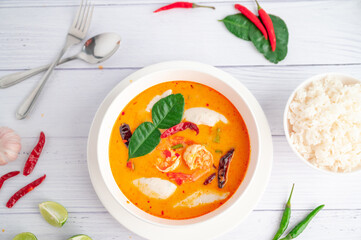 Tom Yum Kung and Fish Balls, Thai food placed on white wooden scene with side dishes.