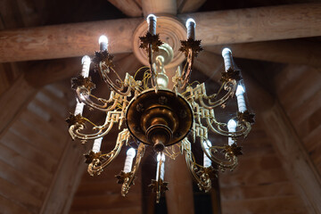 Antique chandelier in a spider web, lamp. Wooden building.