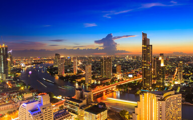 Obraz premium The Capital in the Cityscape view of Bangkok modern office business building in business zone and expressway as long exposure at Bangkok,Thailand