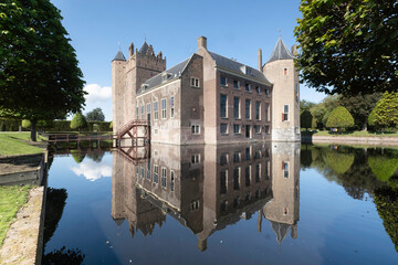 Castle Assumburg in Heemskerk near Amsterdam mirrored in the moat. The castle is nowadays a youth...