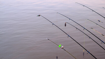 Riverside pier and fishing in sunset light on  river side at