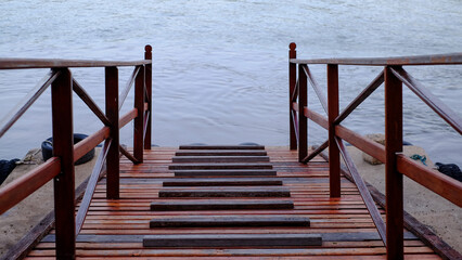 Empty vintage reverside pier .Old wooden houses at side of the river  in Thailand.