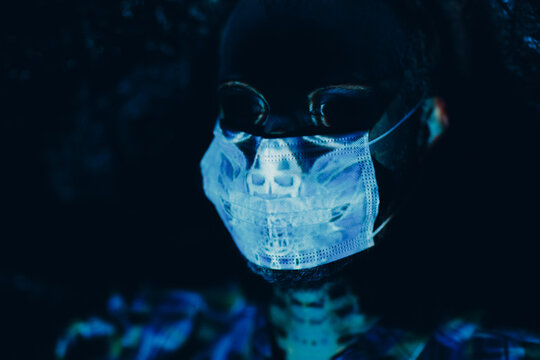 Skull portrait skeleton of adult man in fce medical mask at halloween