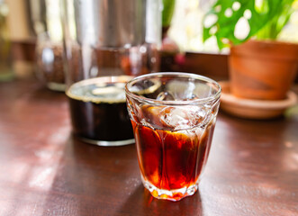 Cold brew coffee on a wooden table, soft focus image.